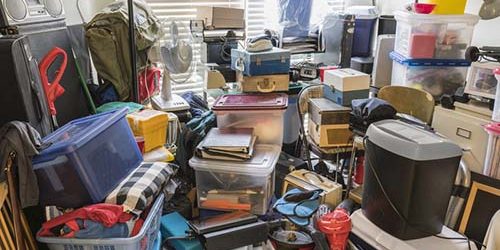 Hoarder Room Packed with Junk and Objects. Hoarder room packed with boxes, electronics, business equipment, household objects and miscellaneous junk.